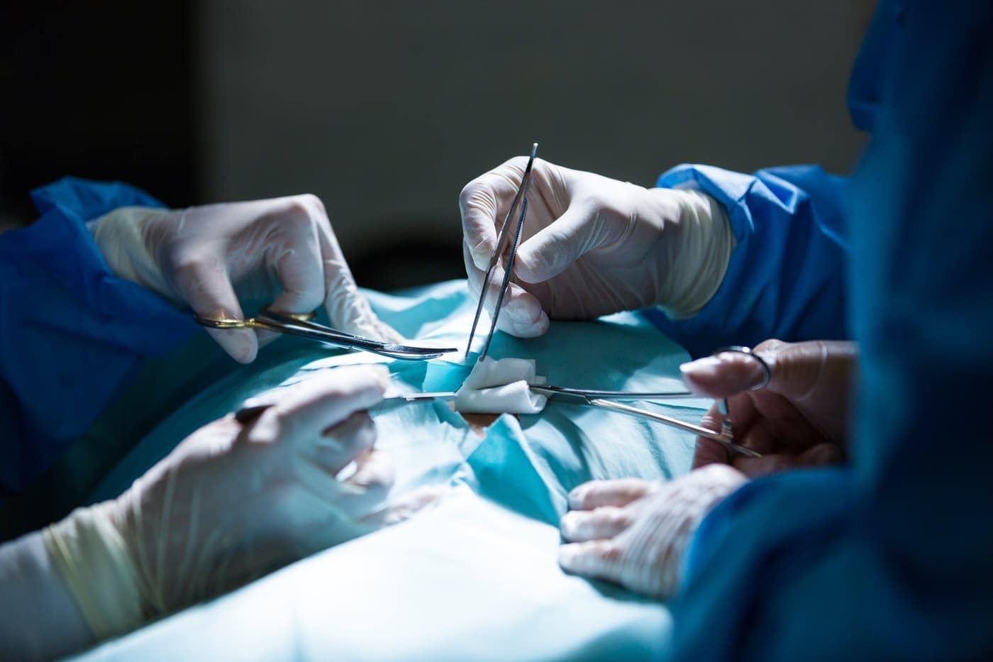 Surgeons performing laparoscopic surgery in the operating room