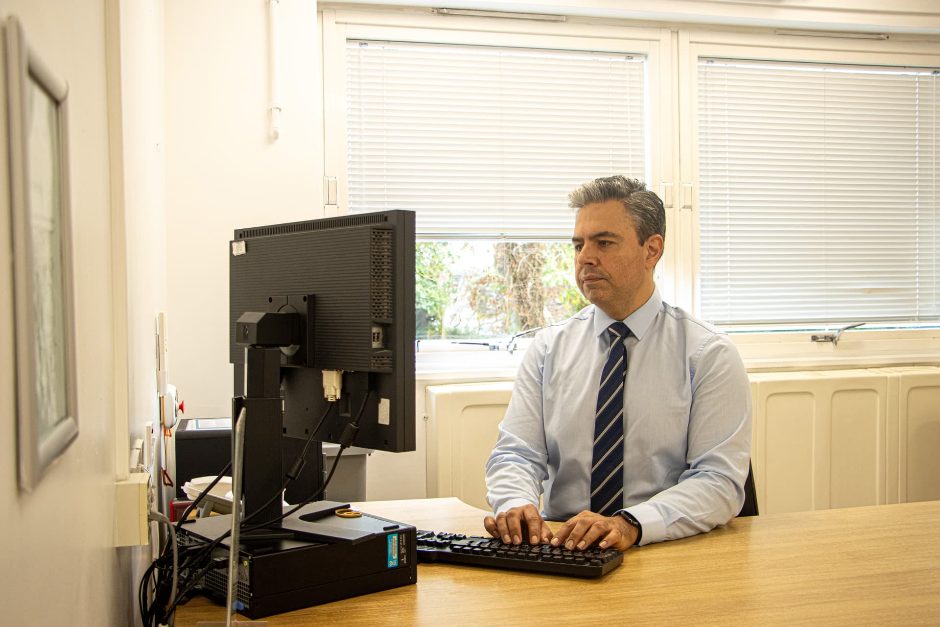 Mr Najib Daulatzai speaking with a patient during a private surgical consultation