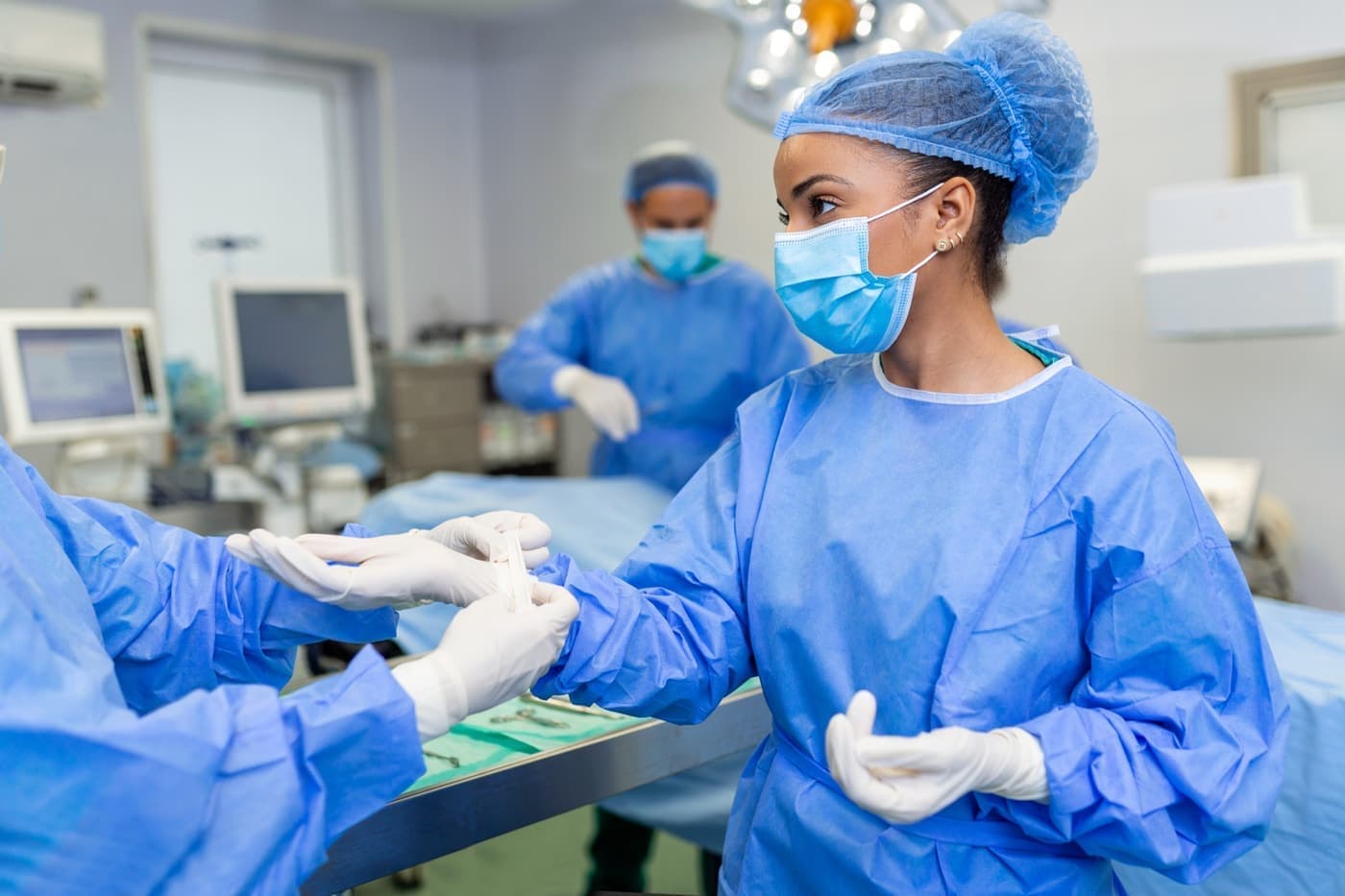 Nurse and surgeon preparing for an operation