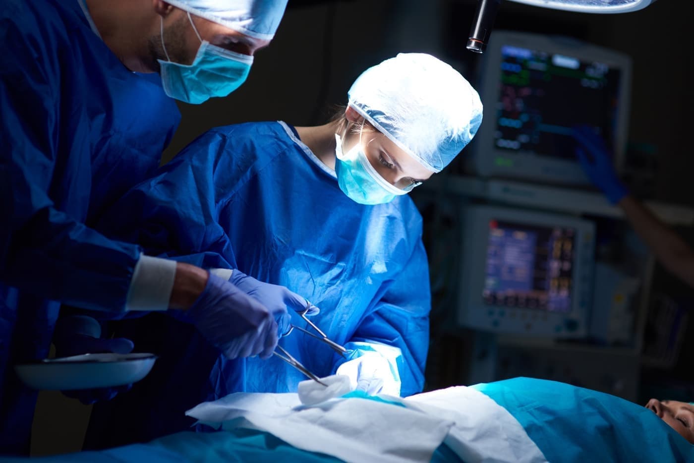 Surgeons performing a focused operation in theatre