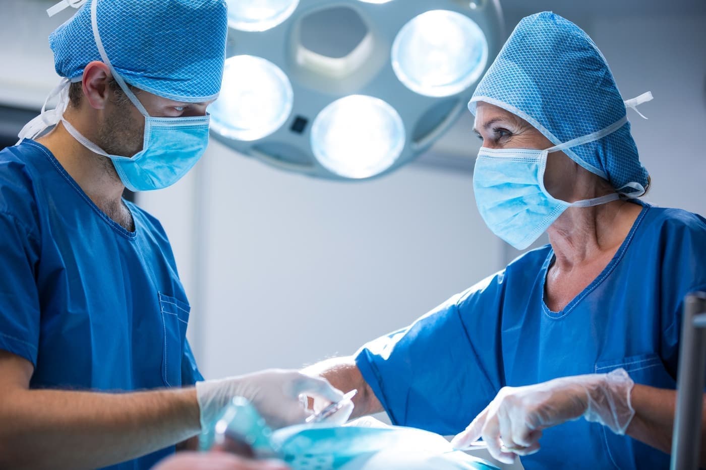 Surgeons performing an operation in a hospital operating room